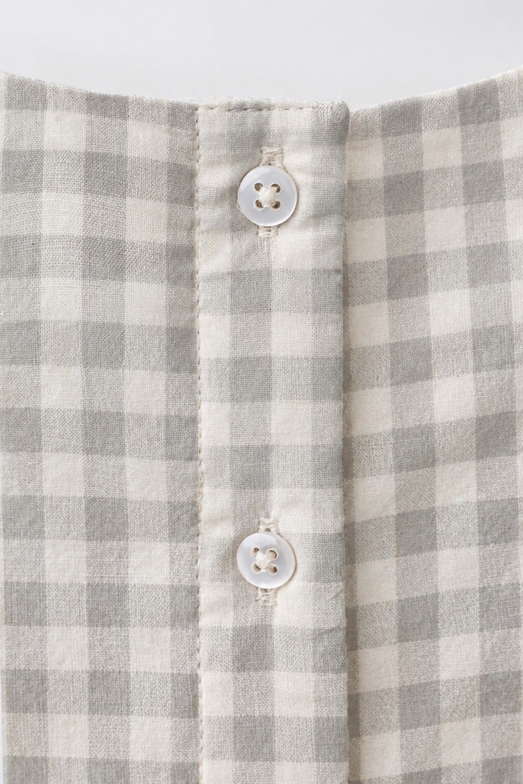Baby wearing Anaario Grey Gingham Lace Frill Romper with frill sleeves, newborn to 24 months