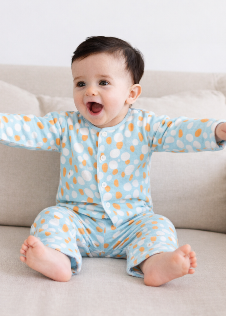 Baby wearing Anaario Ivory and Tangerine Poppy Raindrops organic mulmul cotton Sakura set, newborn to 24 months