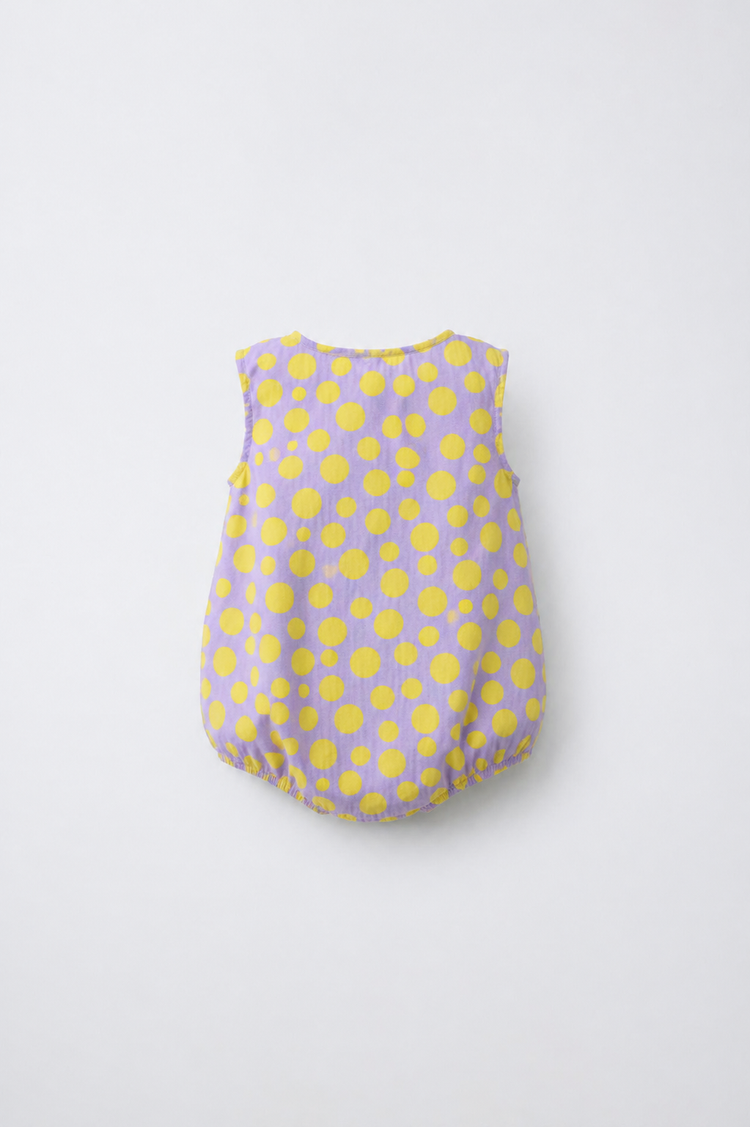 Baby wearing Anaario Lavender Yellow Polka Dot Button sleeveless romper, newborn to 24 months