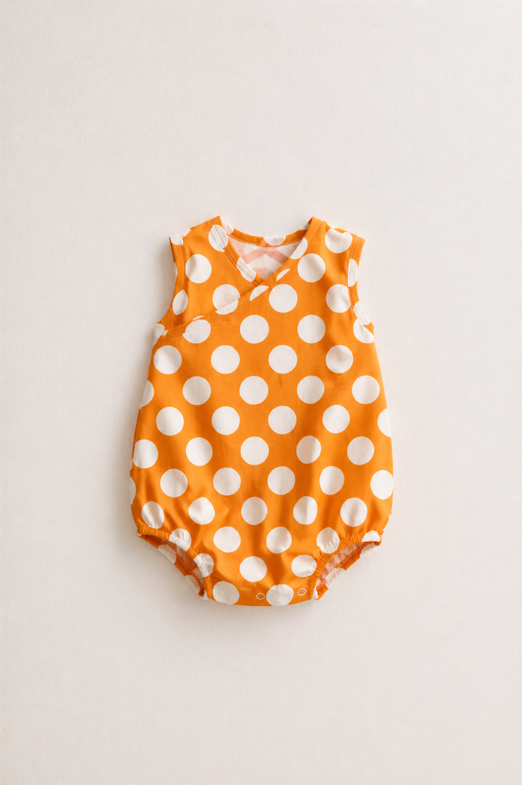 Baby wearing Anaario Orange White Polka Dot Sleeveless wrap-style romper, newborn to 24 months