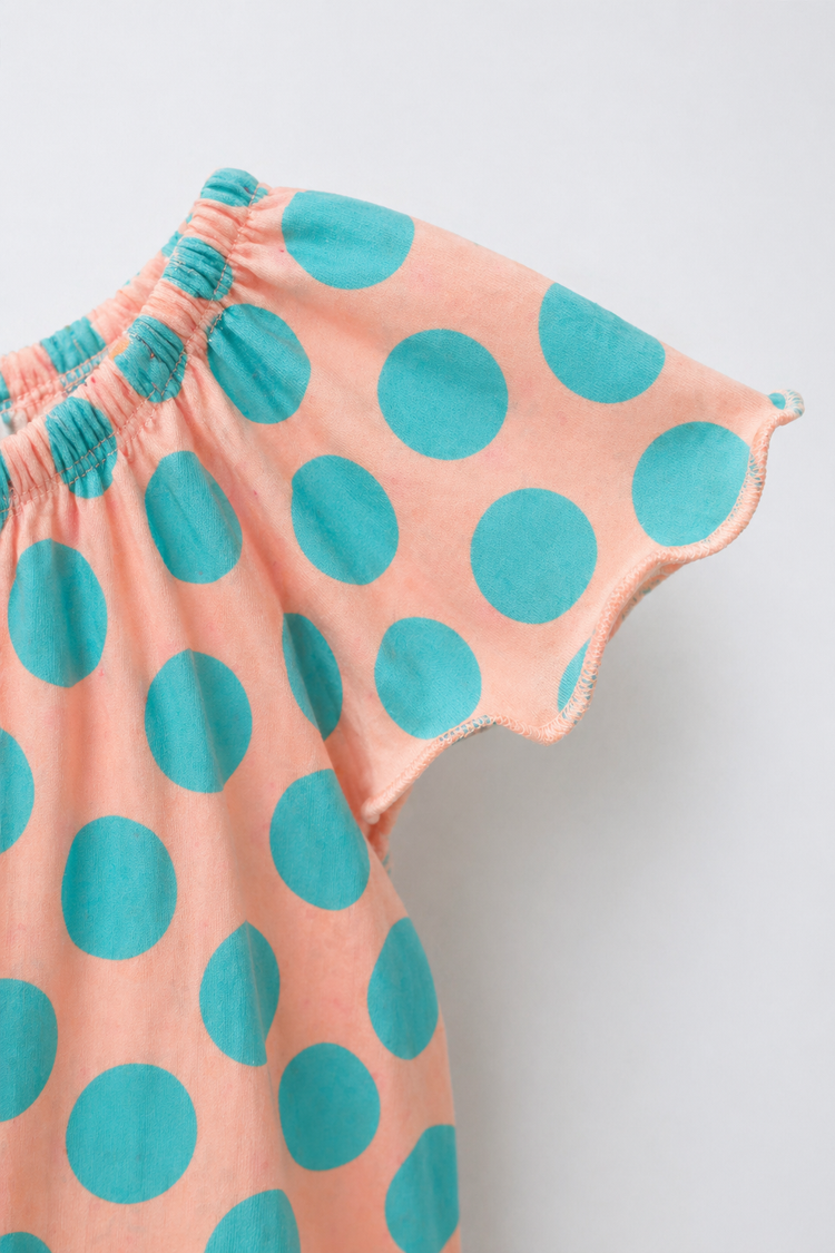 Baby wearing Anaario Peach Aqua Polka Dot Flutter romper, newborn to 24 months