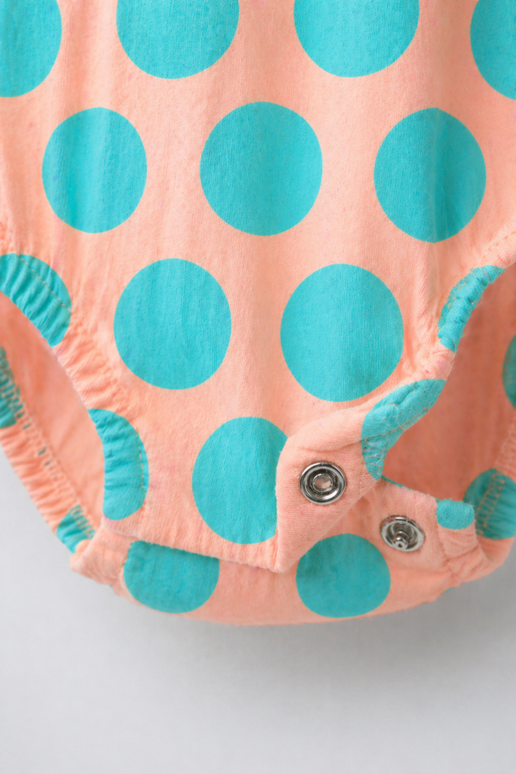 Baby wearing Anaario Peach Aqua Polka Dot Flutter romper, newborn to 24 months