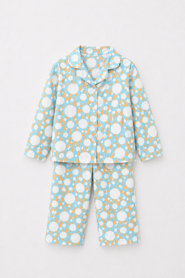 Boy wearing Anaario Ivory and Tangerine Poppy Raindrops Night Suit