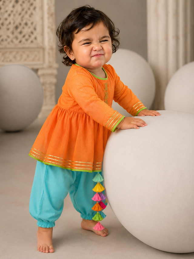 Orange peplum kurta with gold pintuck detailing and sky blue salwar pants for baby girl