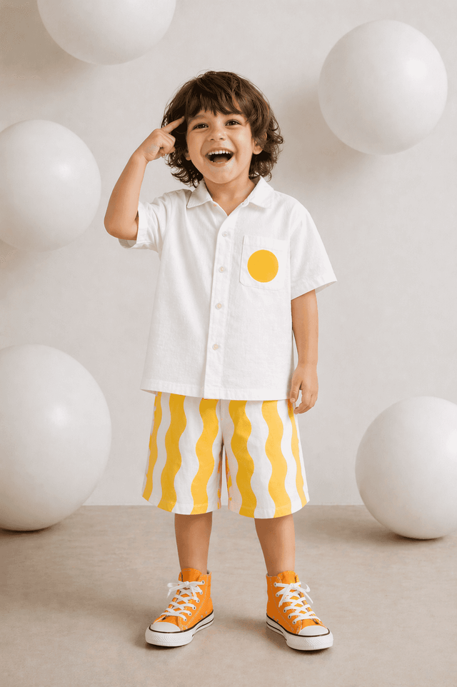 Boy wearing Anaario Sunwave Pocket Shirt Set, white pocket shirt with matching yellow wavy-striped shorts