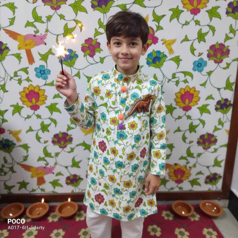 Boy wearing Anaario Garden Kurta Set, white kurta with multicolor floral garden print and dinosaur toy-pocket applique