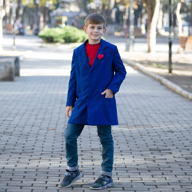 Boy wearing Anaario Arctic Coat, royal blue longline coat with red felt heart pin