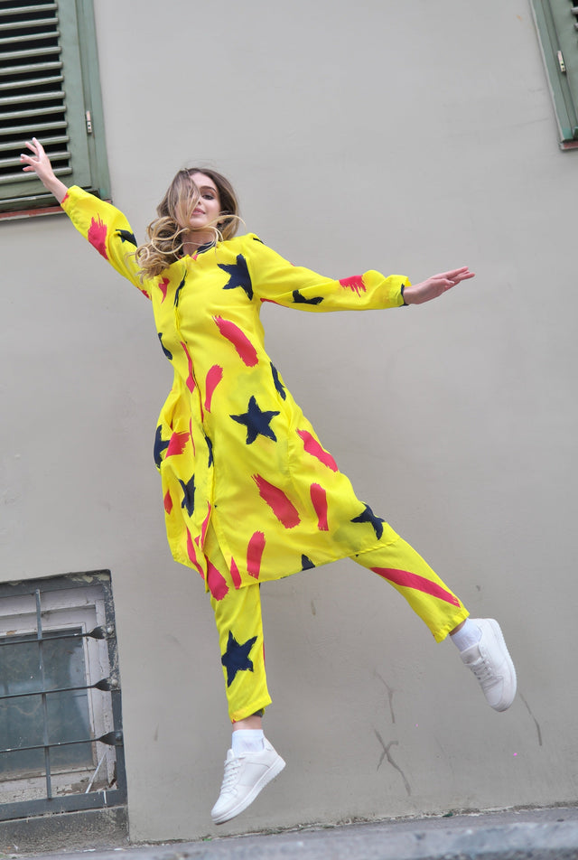 Person wearing Anaario Casablanca Co-ord Set, yellow duster with black star and coral brushstroke print over matching pants