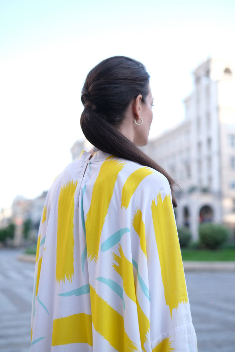 Person wearing Anaario City Girl Co-ord Set, white and yellow abstract print oversized top and matching pants