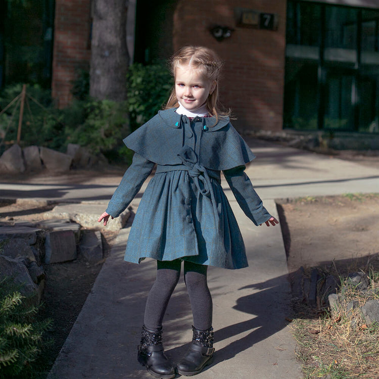 Girl wearing Anaario Diana Capelet Coat, teal wool-look coat with cape collar and tie waist