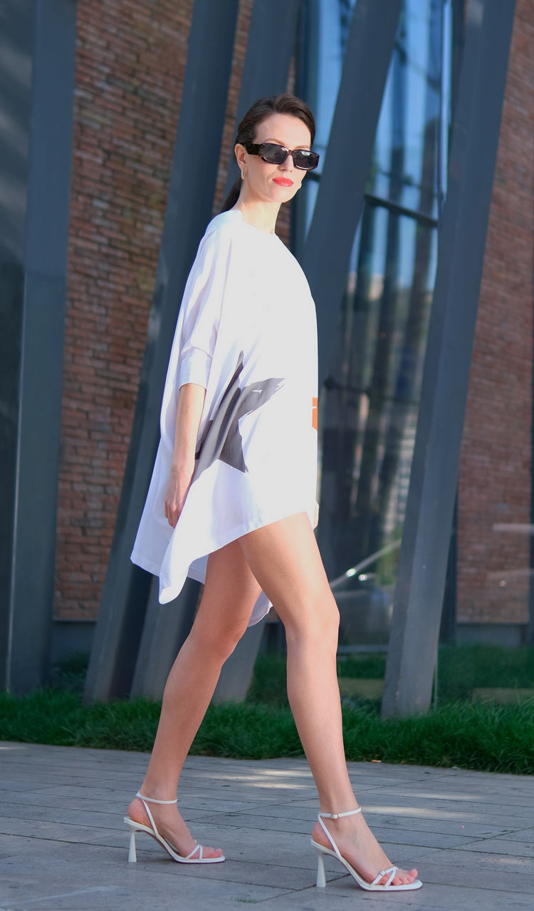 Woman wearing Anaario K Pop Krush Shirt Dress, white oversized shirt dress with teal and orange star graphic