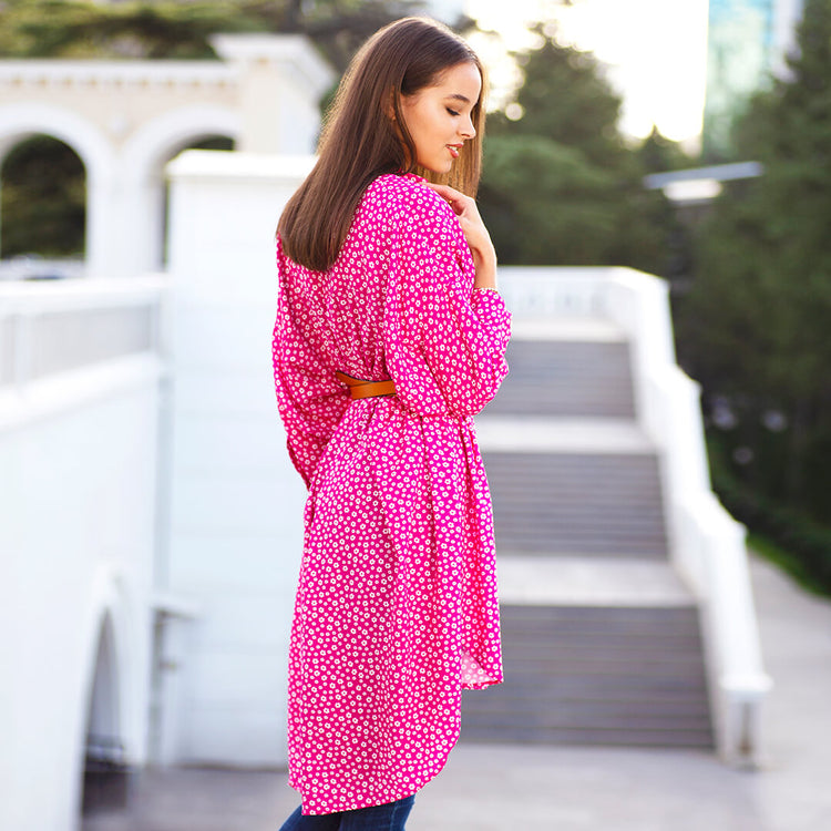 Woman wearing Anaario La Belle Tunic, pink floral print tunic with yellow flower patch and belted waist