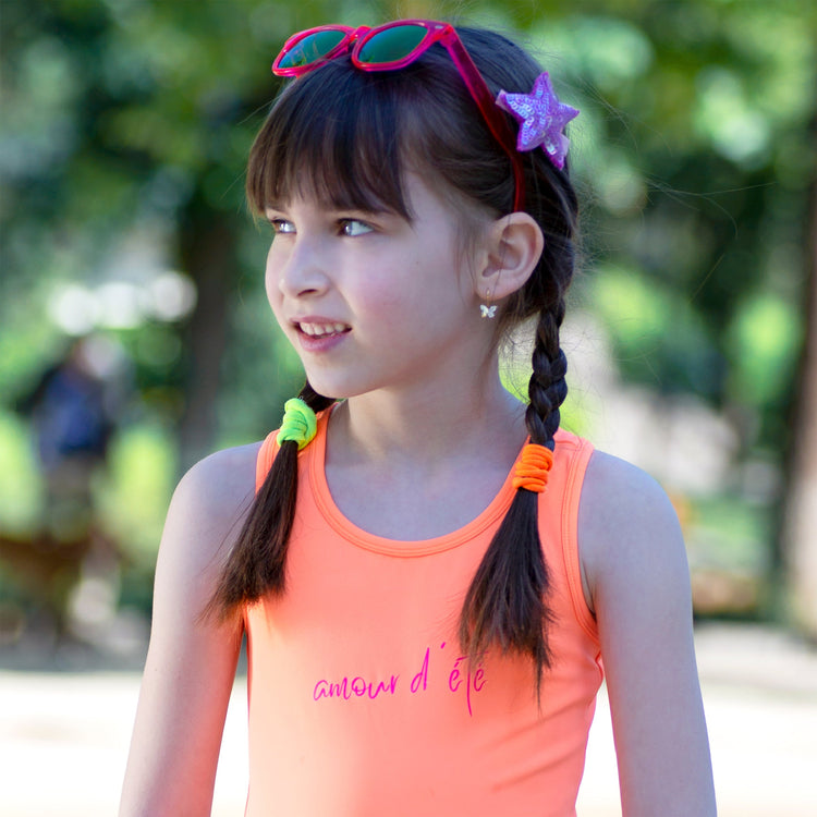 Girl wearing Anaario Orange Purple Star One Piece swimsuit, orange and lilac colorblock one-piece swimsuit with star-point seam design