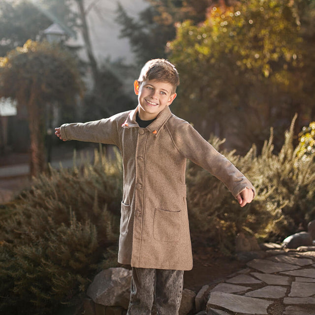 Boy wearing Anaario Rudolph Overcoat, beige longline wool-look overcoat with patch pockets