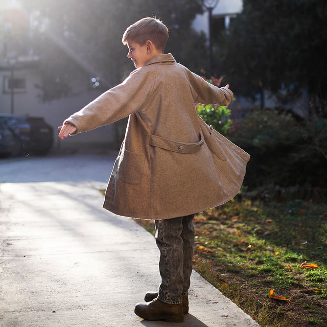 Boy wearing Anaario Rudolph Overcoat, beige longline wool-look overcoat with patch pockets