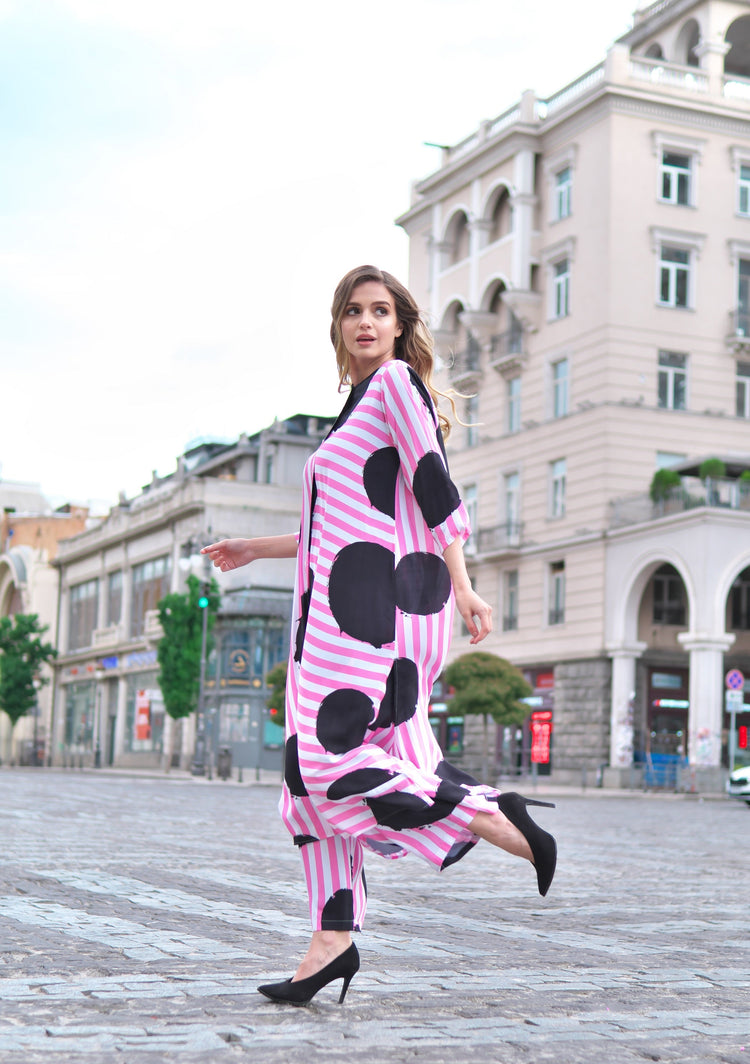Person wearing Anaario Santorini Co-ord Set, pink and white stripe top and pants with black heart print
