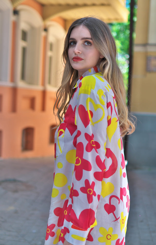 Woman wearing Anaario Sweet Spice Shirt, white shirt with red and yellow floral print