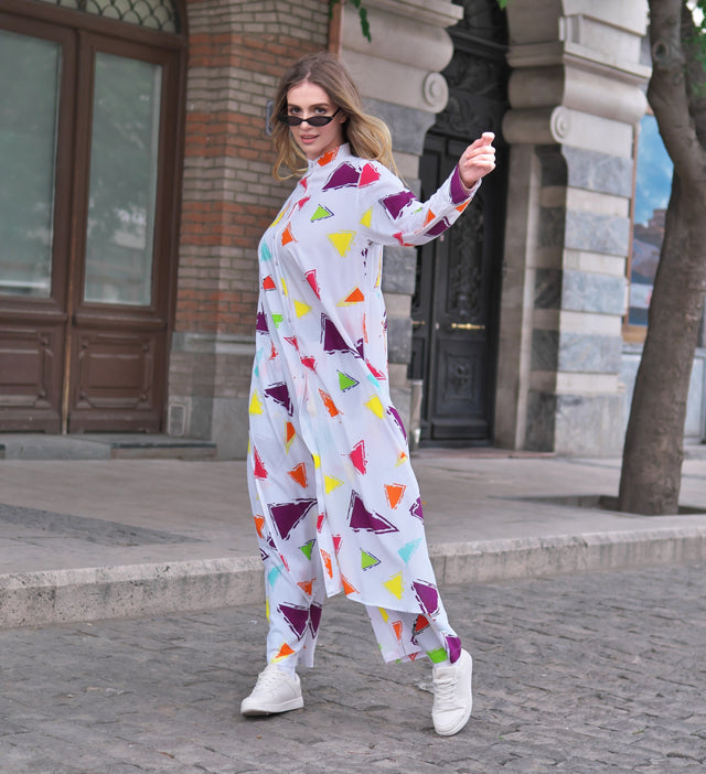 Person wearing Anaario Wild Wanderer Co-ord Set, white maxi duster with multicolor triangle print over matching pants