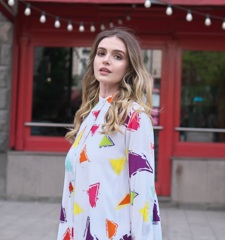Person wearing Anaario Wild Wanderer Co-ord Set, white maxi duster with multicolor triangle print over matching pants