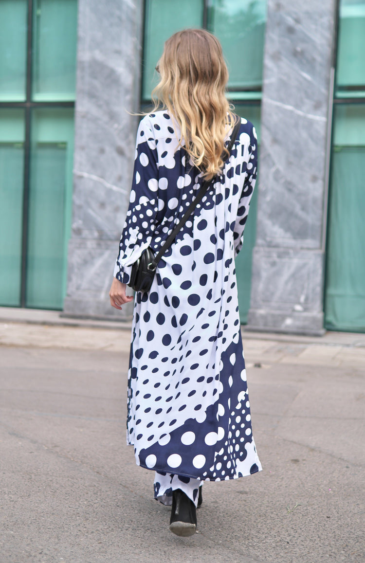 Person wearing Anaario Wild Wanderer Co-ord Set, navy and white mixed polka dot maxi duster with matching pants