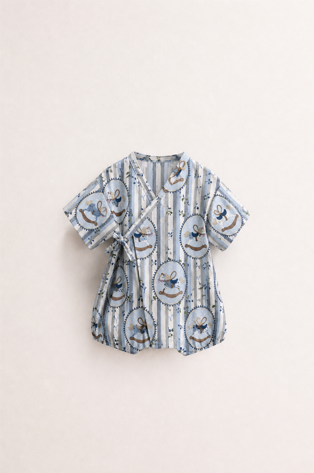 Baby wearing Anaario Blue Rocking Horse Wrap romper, premium organic cotton