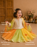 Girl wearing Anaario Orange Green Yellow Lehenga Set