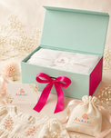 Anaario signature gift box for baby, organic cotton set wrapped in branded tissue with a ribbon, gift card and cotton pouch, ready for gifting