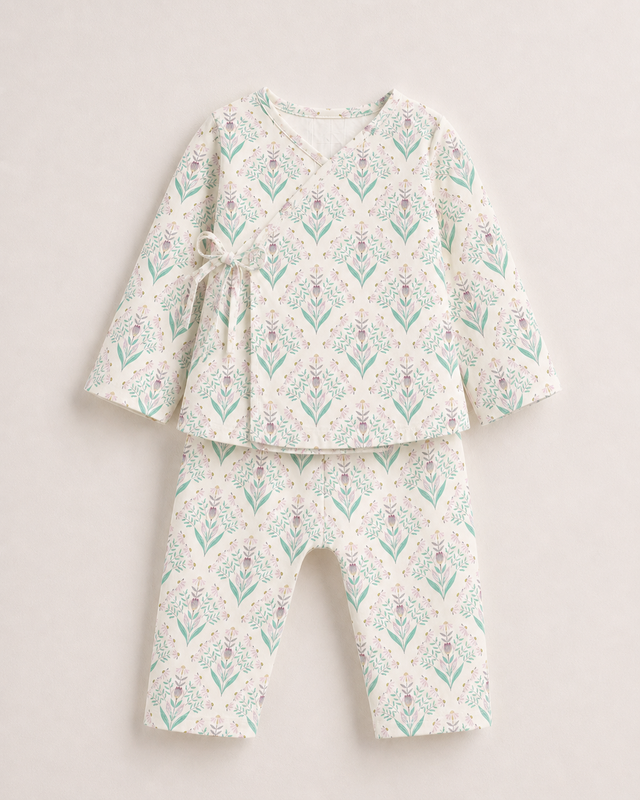 Baby wearing Anaario Aqua Floral Wrap soft aqua floral on ivory co-ord set, newborn to 24 months
