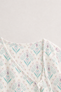 Baby wearing Anaario Aqua Floral Wrap soft aqua floral on ivory co-ord set, newborn to 24 months