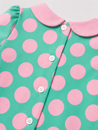 Baby wearing Anaario Aqua Pink Polka Dot Bow short-sleeve romper with Peter Pan collar, newborn to 24 months