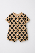 Baby wearing Anaario Beige Black Polka Dot Button short-sleeve romper, newborn to 24 months