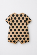 Baby wearing Anaario Beige Black Polka Dot Button short-sleeve romper, newborn to 24 months