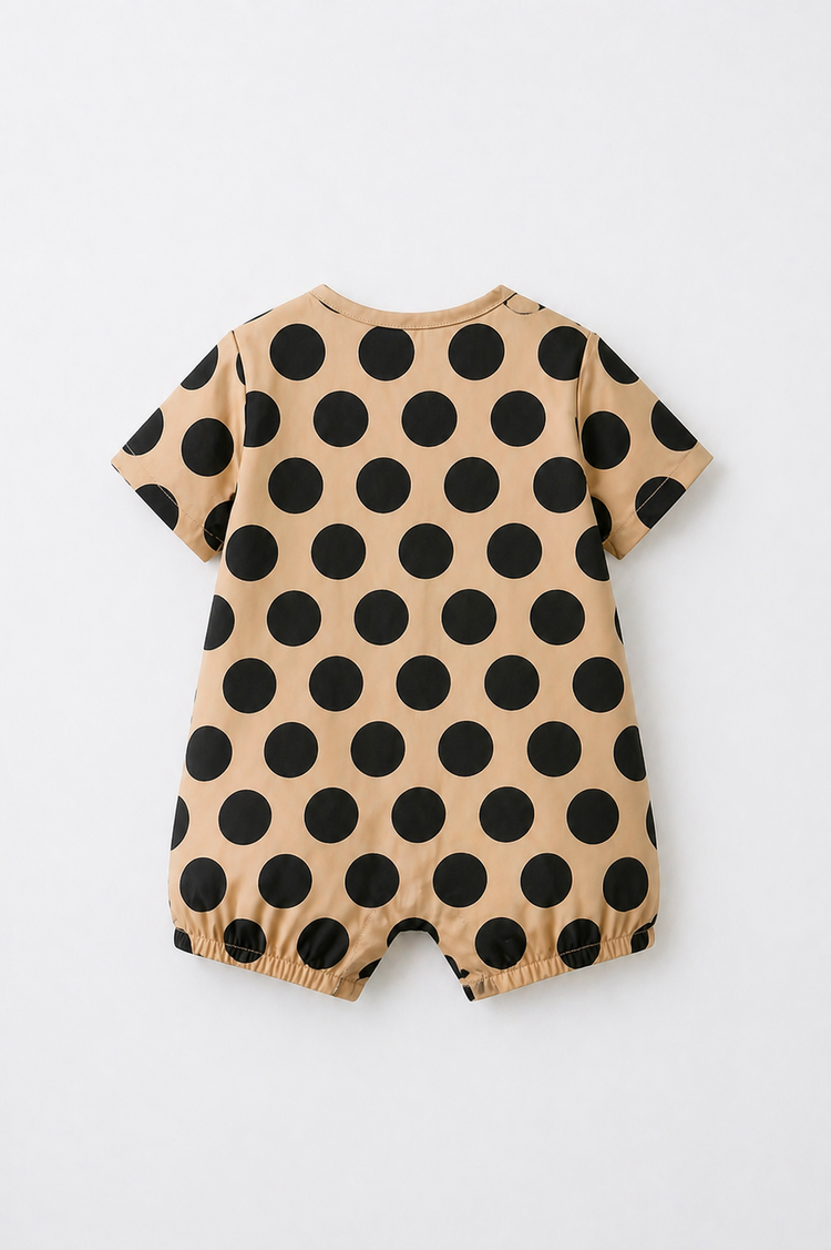 Baby wearing Anaario Beige Black Polka Dot Button short-sleeve romper, newborn to 24 months