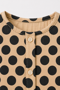 Baby wearing Anaario Beige Black Polka Dot Button short-sleeve romper, newborn to 24 months