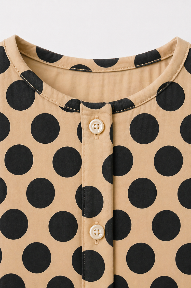 Baby wearing Anaario Beige Black Polka Dot Button short-sleeve romper, newborn to 24 months