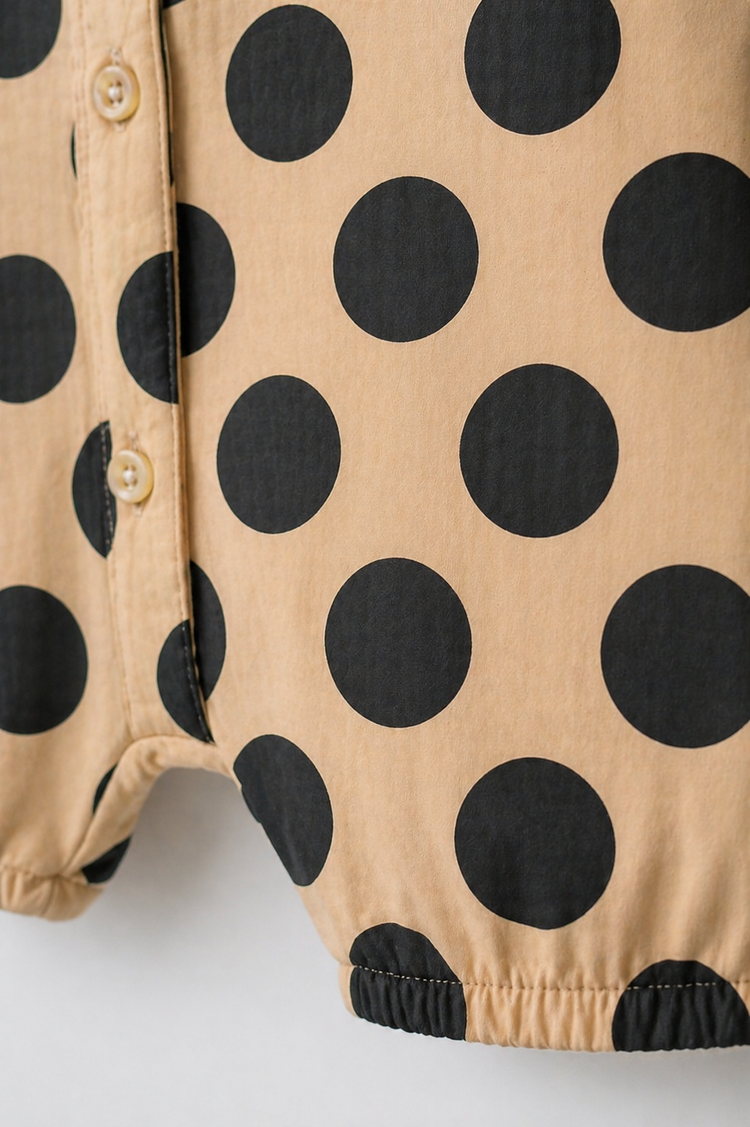 Baby wearing Anaario Beige Black Polka Dot Button short-sleeve romper, newborn to 24 months