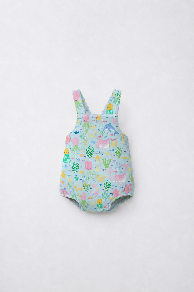 Baby wearing Anaario Sea Friends Pinafore light blue with ocean animals and sea-life prints romper, newborn to 24 months