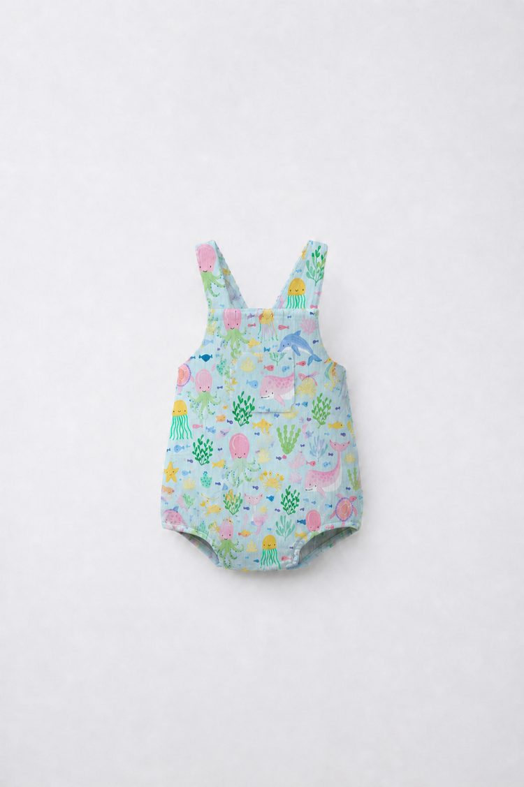 Baby wearing Anaario Sea Friends Pinafore light blue with ocean animals and sea-life prints romper, newborn to 24 months