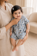 Baby wearing Anaario Blue Rocking Horse Wrap blue stripes with rocking horse prints romper, newborn to 24 months