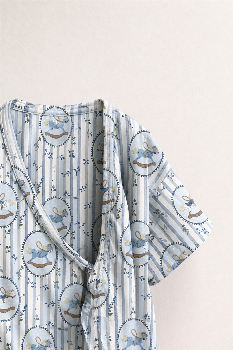Baby wearing Anaario Blue Rocking Horse Wrap blue stripes with rocking horse prints romper, newborn to 24 months