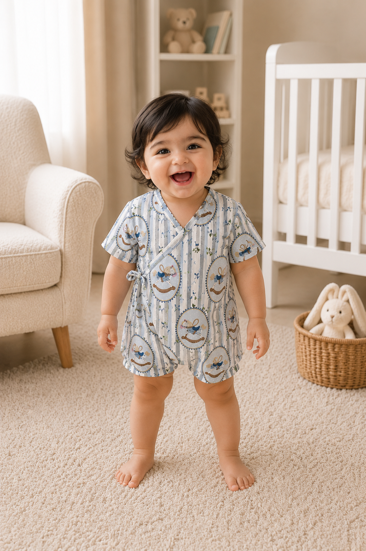 Baby wearing Anaario Blue Rocking Horse Wrap blue stripes with rocking horse prints romper, newborn to 24 months