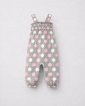 Baby wearing Anaario Blush Dot Smocked grey romper with pink and white polka dots, newborn to 24 months