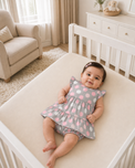 Baby wearing Anaario Blush Dot Tiered grey with pink and white polka dots tiered dress set, newborn to 24 months