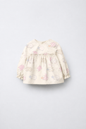 Baby wearing Anaario Cream Sheep Peplum cream with pastel sheep prints co-ord set, newborn to 24 months