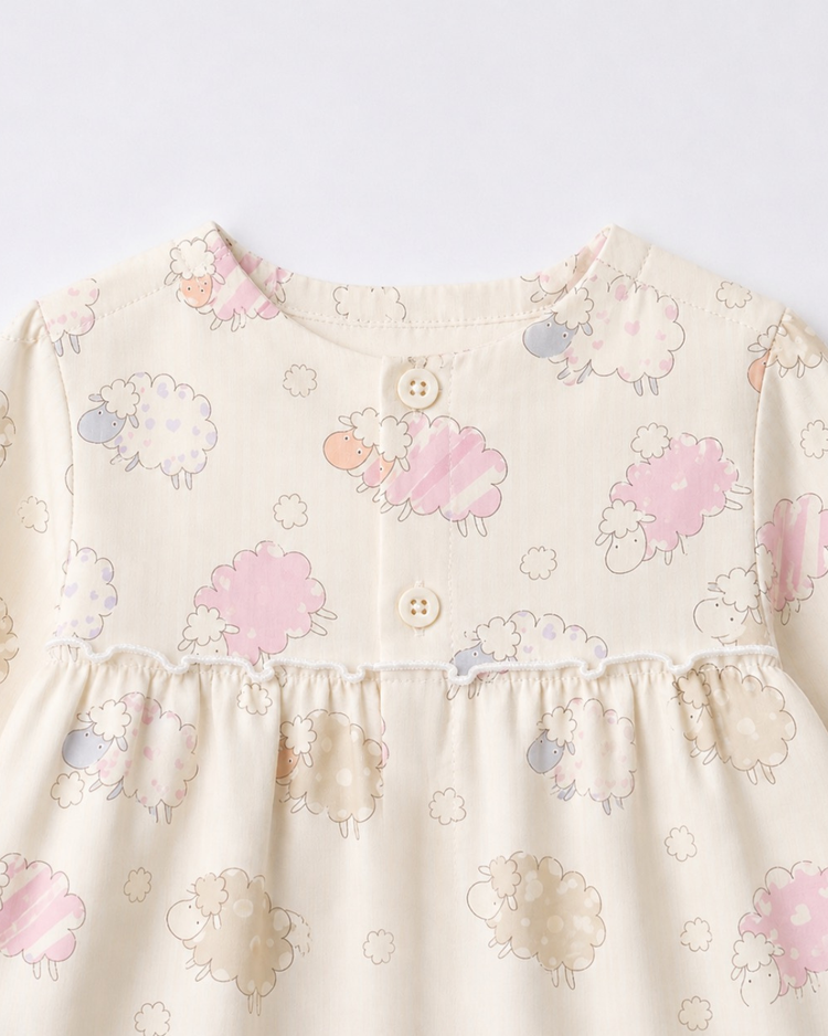 Baby wearing Anaario Cream Sheep Peplum cream with pastel sheep prints co-ord set, newborn to 24 months