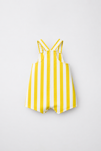Baby wearing Anaario Yellow Stripe romper, yellow and white striped dungaree-style romper, newborn to 24 months