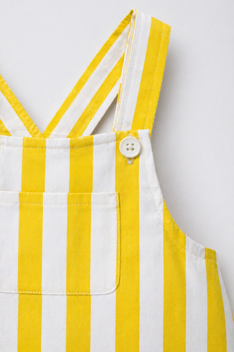 Baby wearing Anaario Yellow Stripe romper, yellow and white striped dungaree-style romper, newborn to 24 months