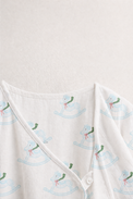 Baby wearing Anaario Rocking Horse Wrap ivory with soft blue rocking horse prints co-ord set, newborn to 24 months
