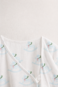 Baby wearing Anaario Rocking Horse Wrap ivory with soft blue rocking horse prints co-ord set, newborn to 24 months