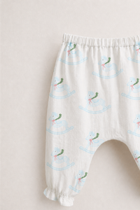 Baby wearing Anaario Rocking Horse Wrap ivory with soft blue rocking horse prints co-ord set, newborn to 24 months